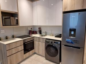 a kitchen with a dishwasher and a washer at Zimbali Lakes Boulevard Suites in Ballito