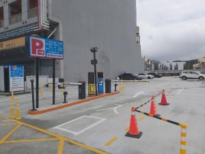 a parking lot with orange cones in front of a gas station at Kending Kaying Hotel in Hengchun South Gate