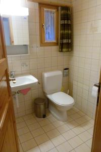 a small bathroom with a toilet and a sink at Ferienhaus Bensel in Alvaneu