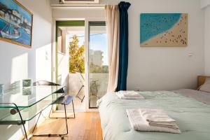 a bedroom with a bed and a glass table at Studio Manolia on the beach in Kalamata