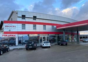 a gas station with cars parked in a parking lot at Motel Papić in Tomislavgrad