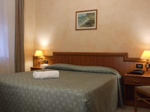 Postel nebo postele na pokoji v ubytování Coccodrillo Hotel & Apartments