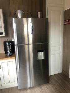 a large stainless steel refrigerator in a kitchen at LE JABLOIRE in Florent-en-Argonne