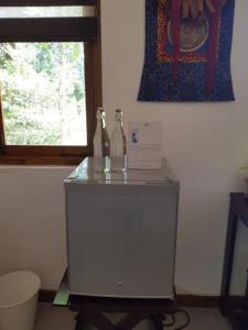 two bottles on top of a cabinet in a room at Zee's Garden in Matale