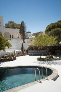 a swimming pool in the middle of a yard at Madame Kalitsi Cozy Suites in Fira