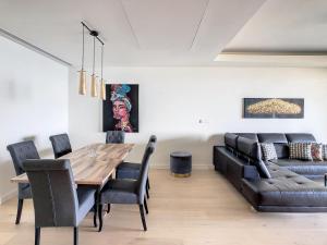 a dining room with a table and a couch at Over the Cliff Apartment by LovelyStay in Funchal