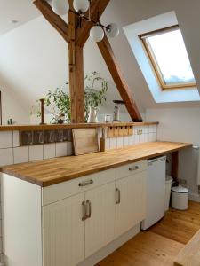 a kitchen with white cabinets and a skylight at Wohnen im Grünen in der Nähe von Leipzig in Machern