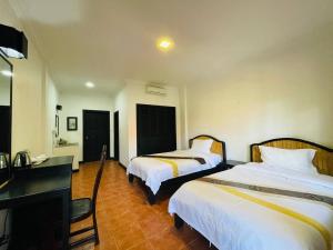 Postel nebo postele na pokoji v ubytování Angkor Tiger Resort