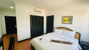 Postel nebo postele na pokoji v ubytování Angkor Tiger Resort