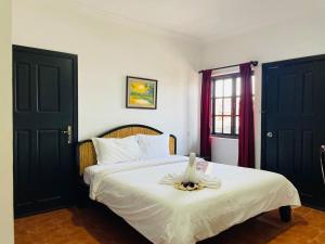 Postel nebo postele na pokoji v ubytování Angkor Tiger Resort