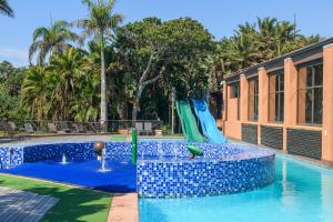 a pool with a water slide in a resort at San Lameer Villa 1939 - 2 Bedroom Classic - 4 pax - San Lameer Rental Agency in Southbroom