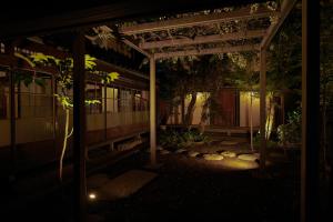 a night view of a building with a pergola at Shirafuji in Suzaka