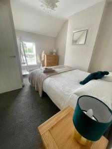 a bedroom with a bed with a blue bowl on it at Entire 2 bed cottage - Llangwm in Llangwm