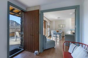 a living room with a sliding glass door to a bedroom at Bonita stay B Paz:Casa grande, Piscina, BBQ,Fibra in Panticosa