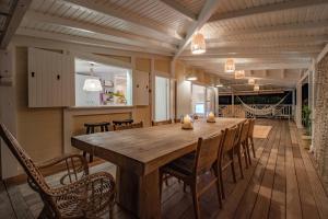 comedor grande con mesa de madera y sillas en Villa La Vanille à Marie Galante - vue mer & piscine, en Grand-Bourg