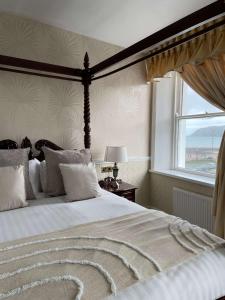 een slaapkamer met een groot bed en een groot raam bij Montclare in Llandudno