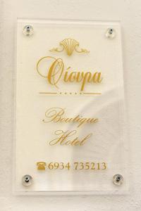 a sign for a boutique hotel in gold at Oisyra Boutique Suites in Ermoupoli