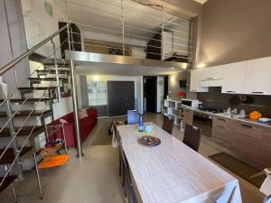 a kitchen with a table and a staircase in a room at Marconi e Garibaldi 76 apartment in Castellammare del Golfo