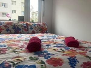 a bed with red knitted mittens on top of it at Apartament tuż za rogiem Zamku in Malbork
