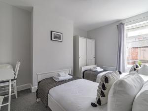 a hotel room with two beds and a window at East House - 3 bedroom- Stakeford, Northumberland in Hirst