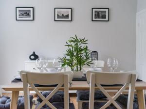 a dining room with a wooden table and chairs at East House - 3 bedroom- Stakeford, Northumberland in Hirst