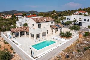 an aerial view of a house with a swimming pool at Villa Stina Jezera, Murter in Jezera