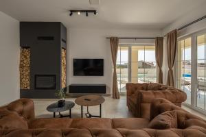 a living room with a couch and a tv at Villa Stina Jezera, Murter in Jezera