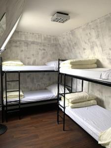 a dorm room with three bunk beds in it at Amigo Hotel in Amsterdam
