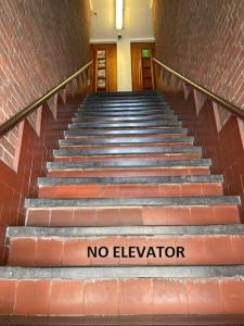 a staircase with a sign that says no elevator at Amigo Hotel in Amsterdam