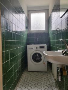 a bathroom with a washing machine and a sink at Monteurunterkunft Licherode 