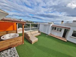 a balcony with green grass on a roof at Penthouse with private pool, hot tub jacuzzi with sea views and chill-out zone, close to the sea in Marbella