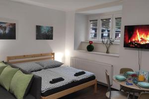 a bedroom with a bed and a table with a fireplace at Cozy basement flat, SkyShowtime, 3 minutes to center in Prague