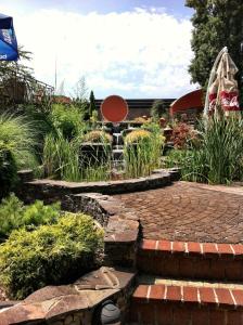 a garden with a stone path and a fountain at Therma Nea Dunajská Streda in Dunajská Streda +90 photos