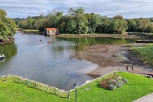 a river with a building in the middle of it at 2 Bed Gated Apartment Westport in Westport