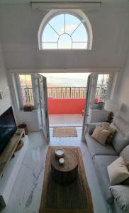 a living room with a couch and a table at New beachfront duplex - sleeps up to 4 in Gibraltar