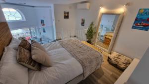 a bedroom with a bed and a large mirror at New beachfront duplex - sleeps up to 4 in Gibraltar