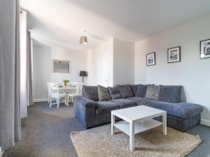 a living room with a couch and a table at Lilys Apartment 2- 2bedroom, Northumberland in Bedlington