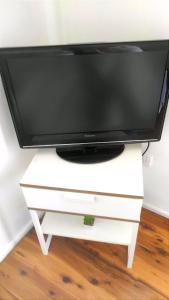 a television on a white stand with a tv at Lovely Queen Room + TV +Wifi FREE Parking Pet Friendly in Glenfield
