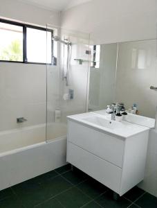 a white bathroom with a sink and a shower at Lovely Queen Room + TV +Wifi FREE Parking Pet Friendly in Glenfield