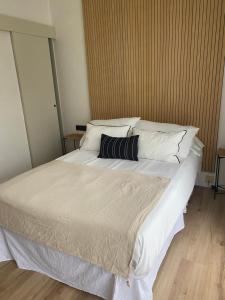 A bed or beds in a room at Pensión Residencia Fornos