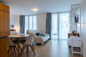 a living room with a table and a couch at Atlantic Sagres in Sagres