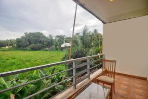 a balcony of a house with a view of a field at Down D Village Wing 2 in Candolim