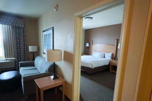 a hotel room with a bed and a couch at MainStay Suites Williston in Williston