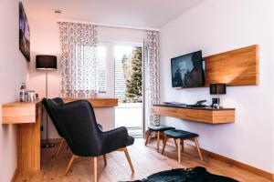 a room with a desk and a chair and a window at Haus Sommerberg in Feldberg