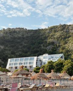 a building with a bunch of chairs in front of it at Prince Adriatic Resort in Shëngjin