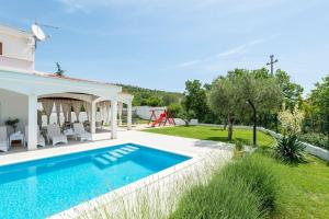 a villa with a swimming pool and a garden at Luxurious private family resort with mountain view in Šestanovac