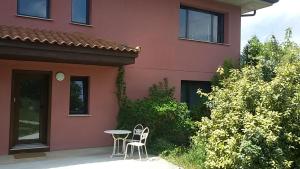 a table and chairs sitting outside of a house at Lovely Cat's B&B in Urrúnaga +12 photos