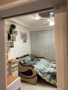 a bedroom with a bed and a ceiling at Frendly Flat Free Parking Kitchen Equipment Cosy in Rīga