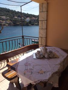 a table on a balcony with a view of the water at Apartments Nives in Smokvica +37 photos