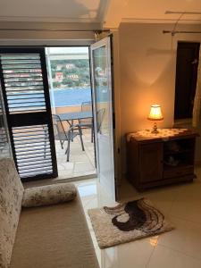a living room with a door leading to a patio at Apartments Nives in Smokvica